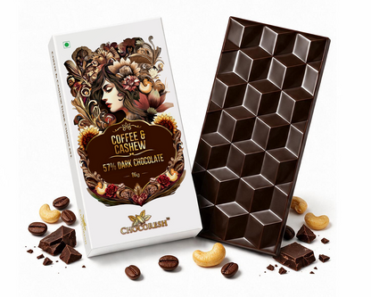 A bar of chocolate and its decorative packaging box on a white background, with scattered chocolate pieces, coffee beans, and cashews around them. The box reads 'Coffee & Cashew 5% Dark Chocolate' and shows an ornate illustrated label.